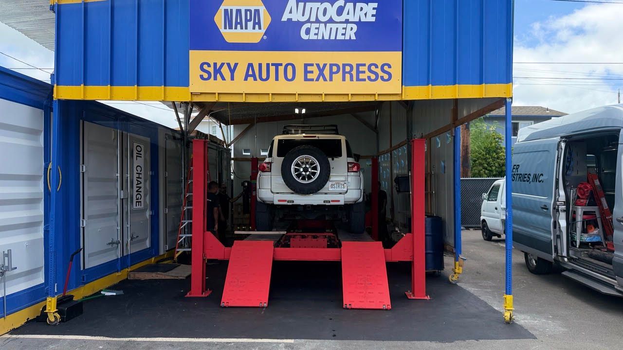 Auto repair shop entrance with a vehicle on a lift | Sky Auto Repair