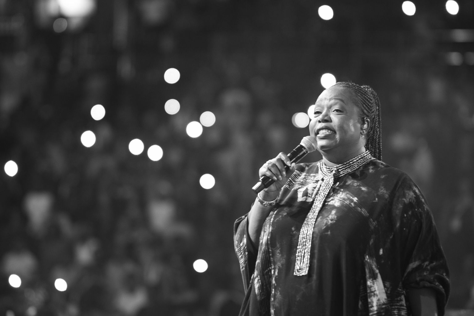 Black-and-white close-up of Chevelle Franklyn smiling during her performance.