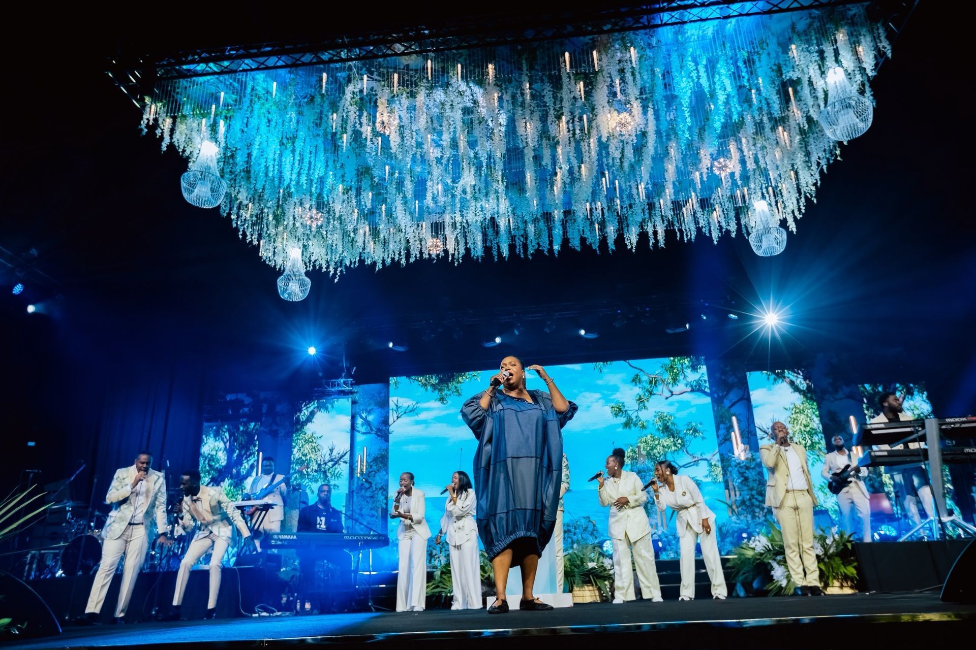 Chevelle Franklyn and backing vocalists beneath the chandelier at All Women Together 2026, Kigali.