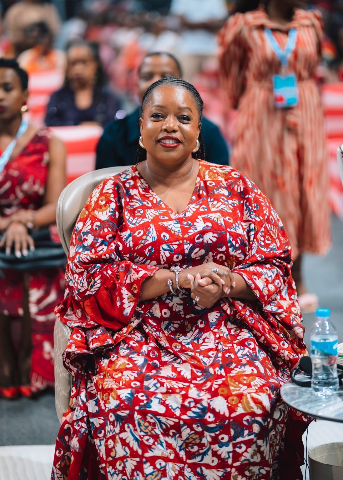 Chevelle Franklyn seated in a red patterned dress at All Women Together 2026, Kigali.