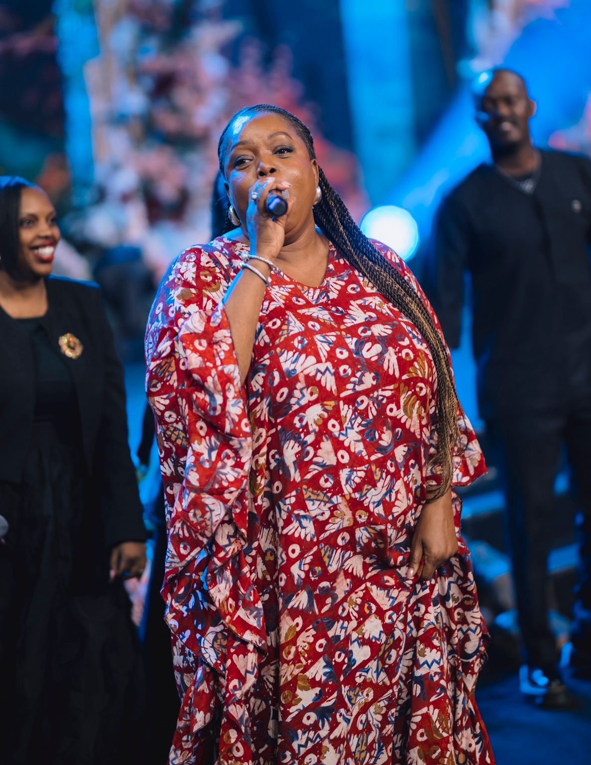 Chevelle Franklyn singing in a red patterned dress at All Women Together 2026, Kigali.