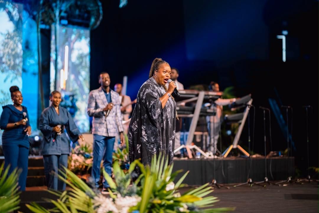 Wide stage view of Chevelle Franklyn in a black dress with backing vocalists at All Women Together 2026, Kigali.