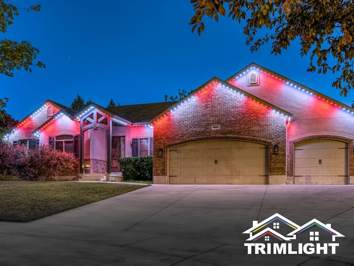 House with red and white lights along the roofline, blue sky, and Trimlight logo.