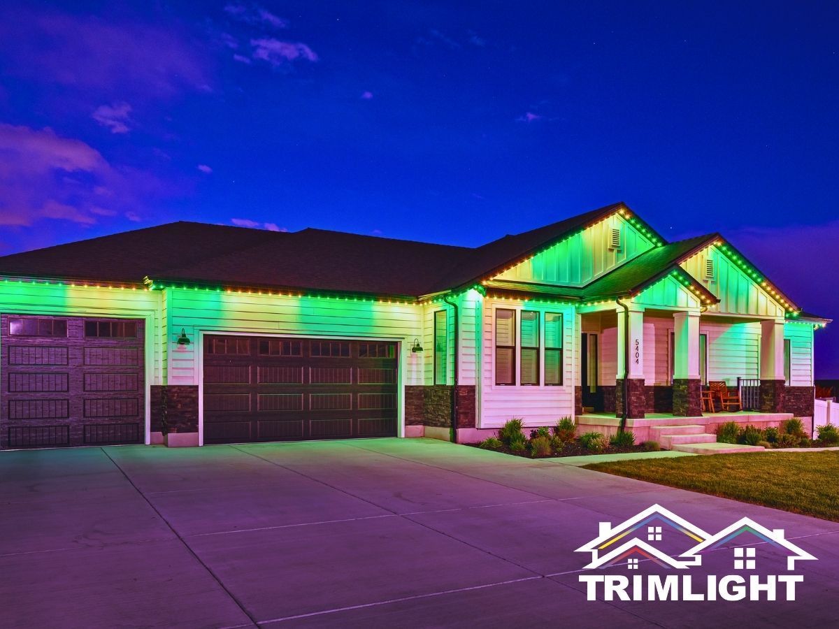 House exterior lit with green and purple lights at dusk. Logo