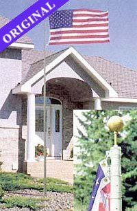 An american flag is flying in front of a house.