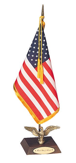 A small american flag on a stand with an eagle on top