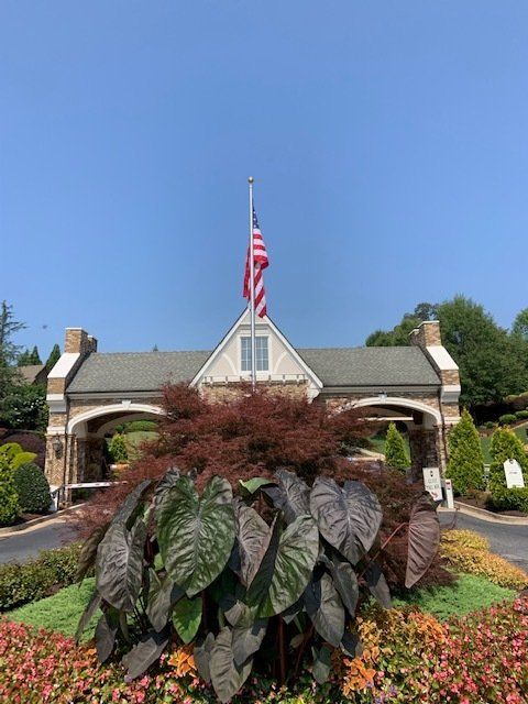 An american flag is flying in front of a building.
