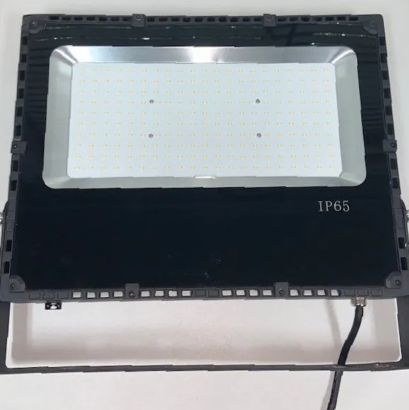 A flood light with ip65 written on it is sitting on a table.