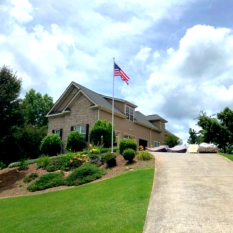 A house with an american flag flying in front of it