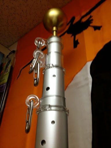A flag pole with a witch silhouette on it