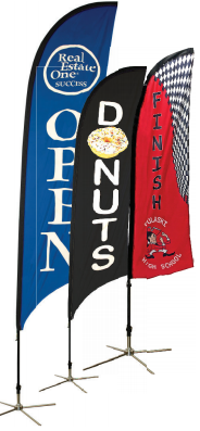 Three flags with one that says donuts on it