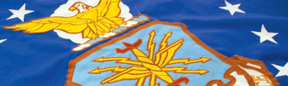 A close up of a flag with a mountain and stars on it.