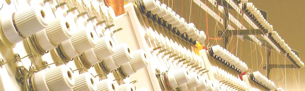 Custom Flag Sewing Machine A close up of a row of white keys on a piano keyboard.
