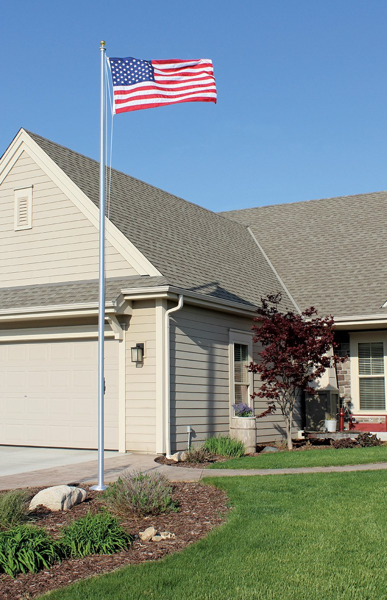 An american flag is flying in front of a house