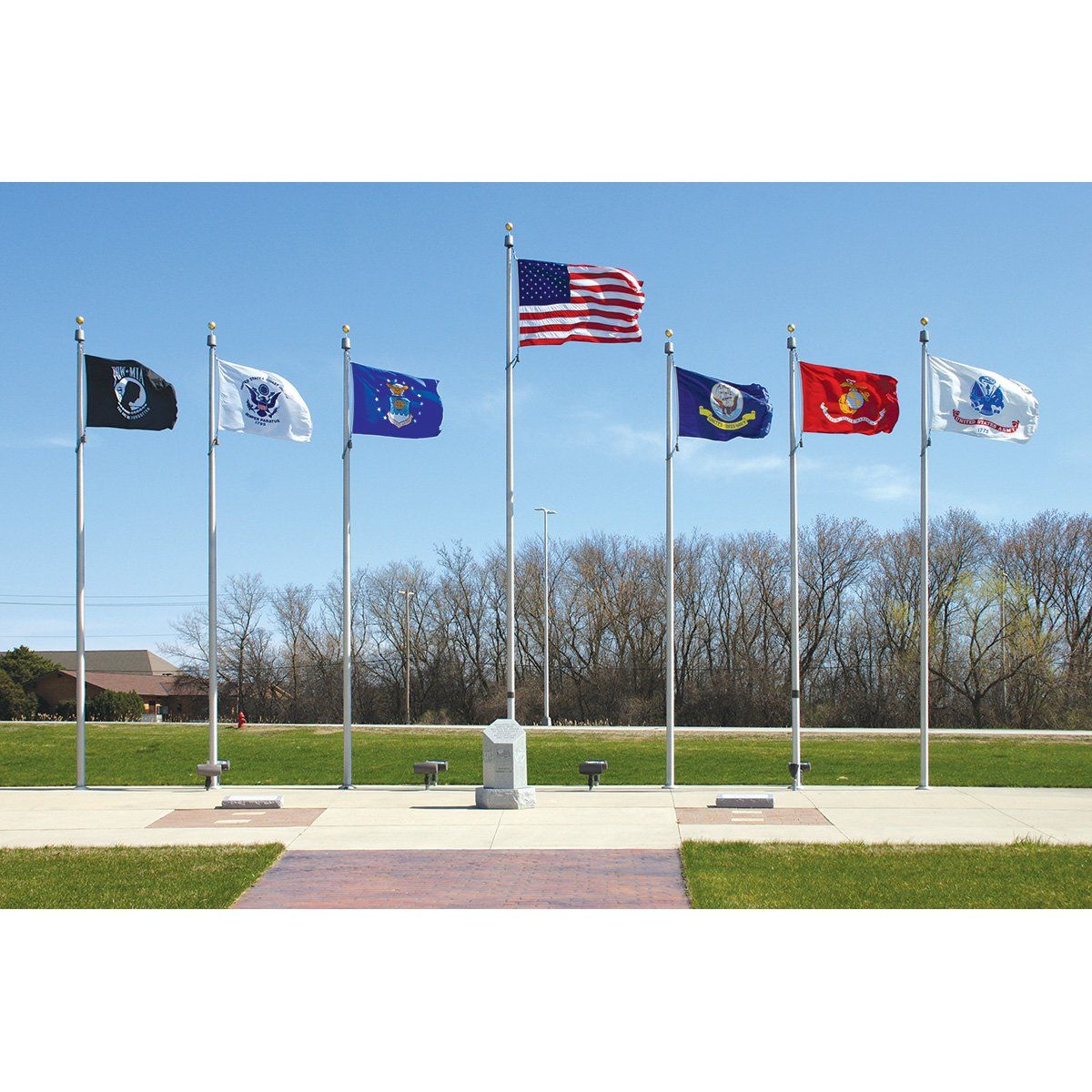 A row of flags are flying in a field