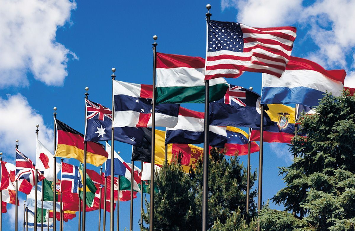 A bunch of flags are waving in the wind