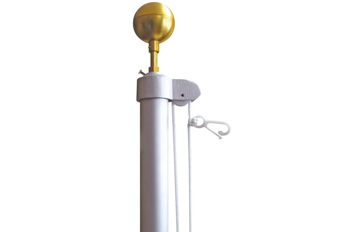 A flag pole with a gold ball on top of it.