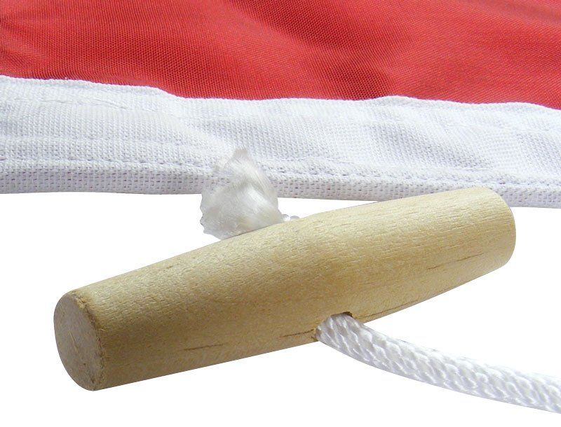 A red and white flag with a wooden handle attached to it