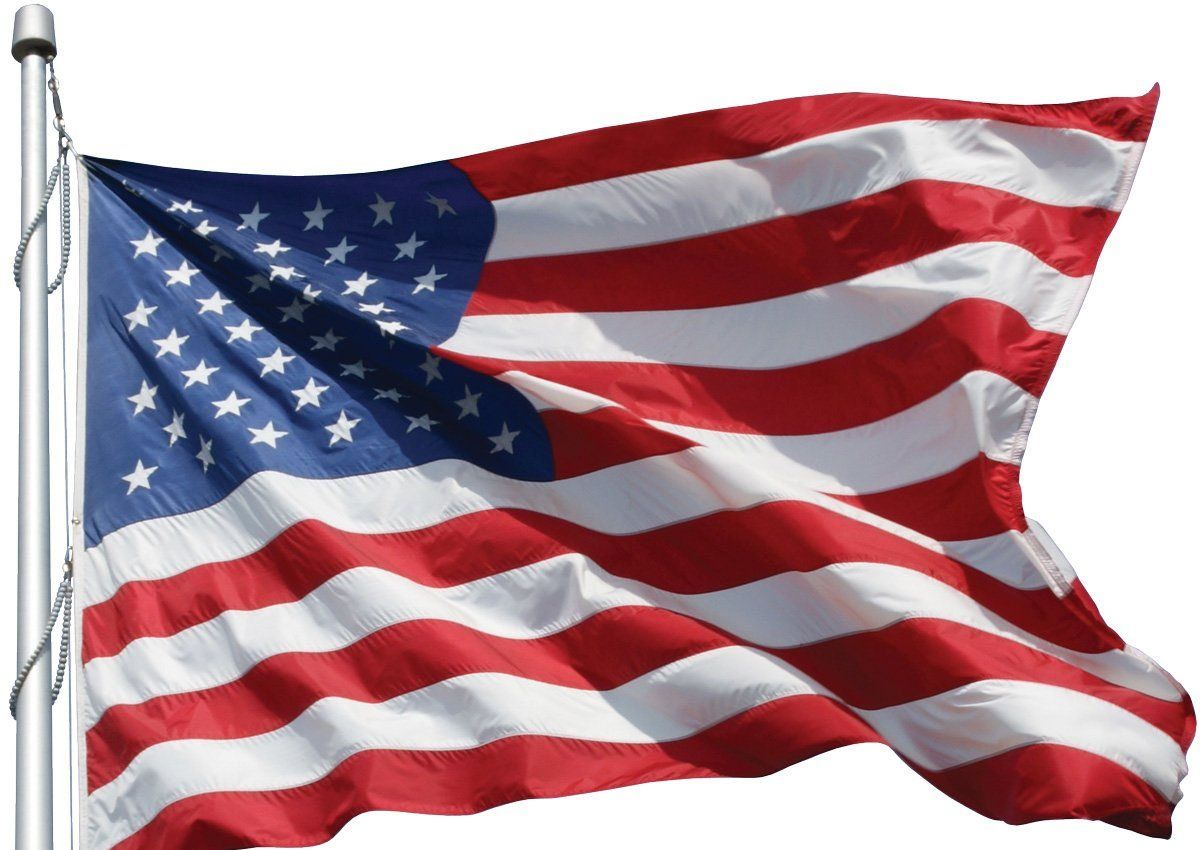A large american flag is waving in the wind