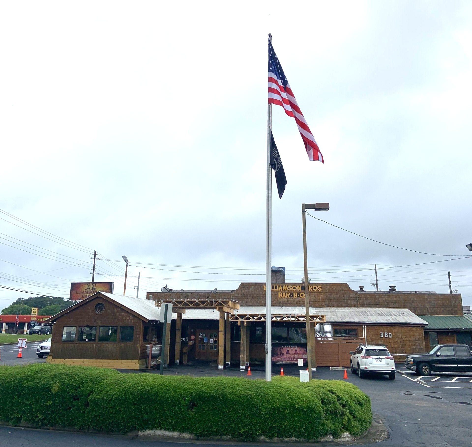 An american flag is flying in front of a building
