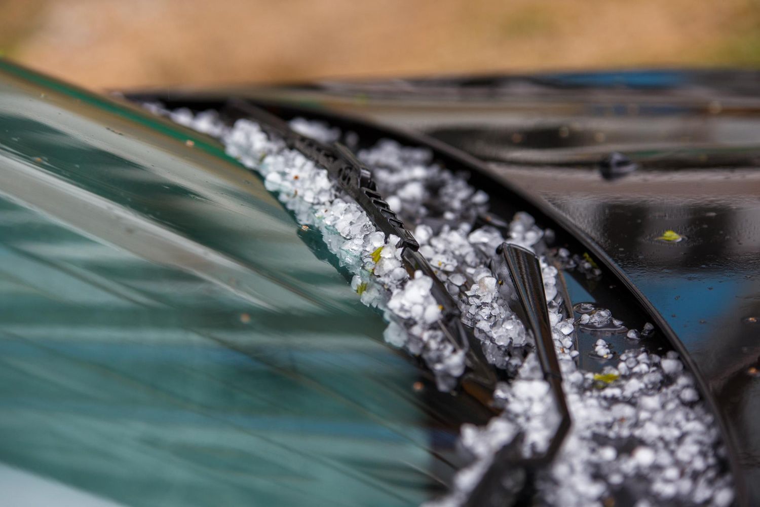 Close-up of a car windshield wiper with snow and ice buildup on the windshield