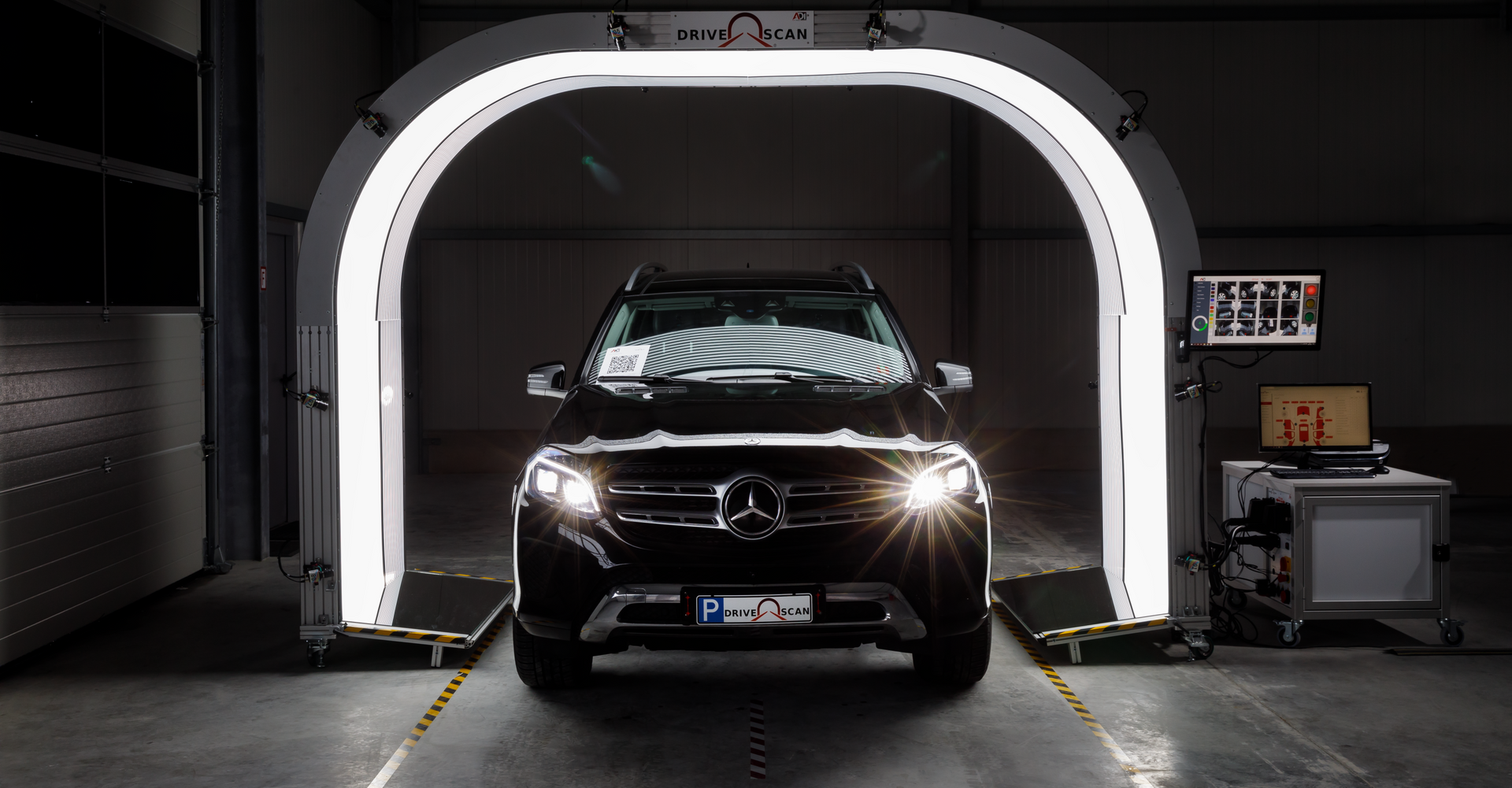 a Mercedes is going through a drive scan tunnel