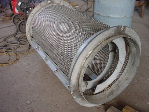 A large metal pipe with a stainless steel mesh on it