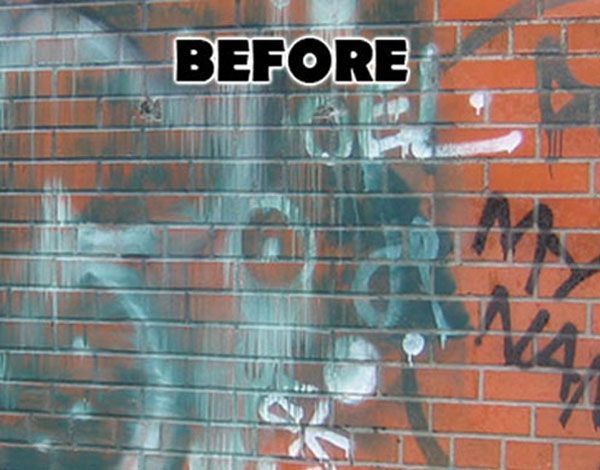 A before picture of a brick wall with graffiti on it