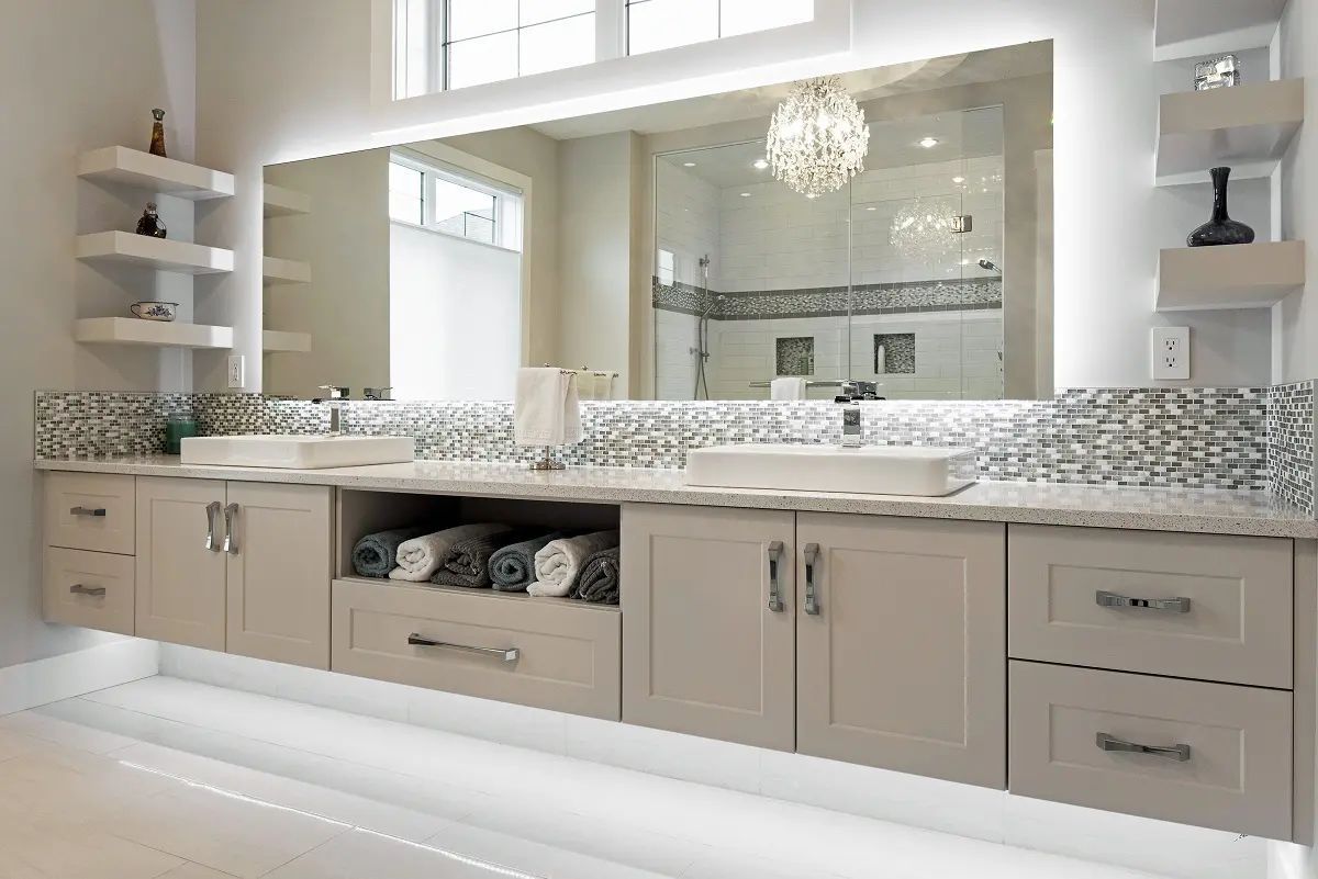Modern bathroom with floating vanity, large mirror, and shelving. Soft lighting and neutral color scheme.