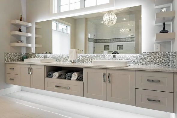 Modern bathroom with floating vanity, large mirror, and shelving. Soft lighting and neutral color scheme.