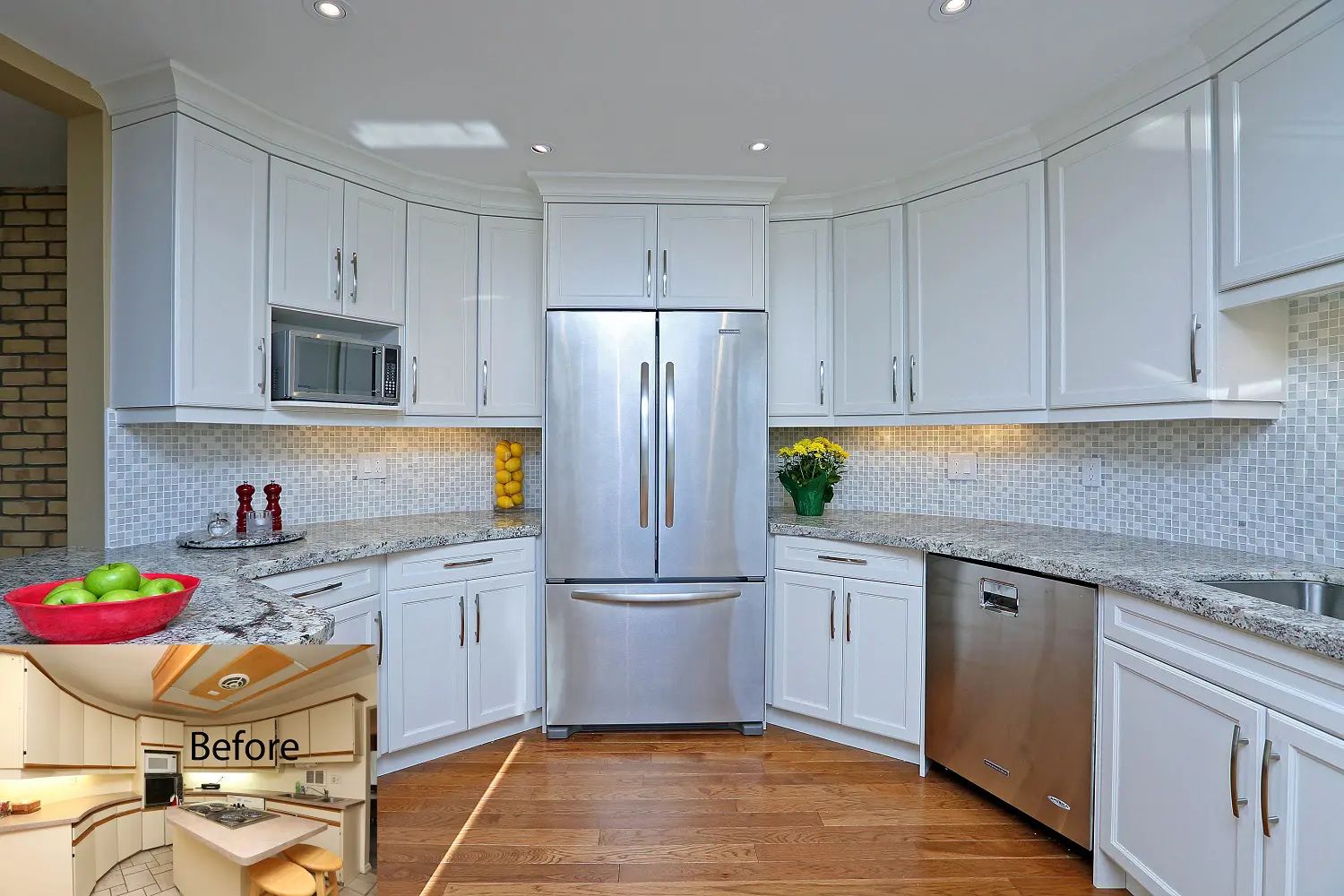 White kitchen with stainless steel appliances, granite countertops, and curved cabinets.