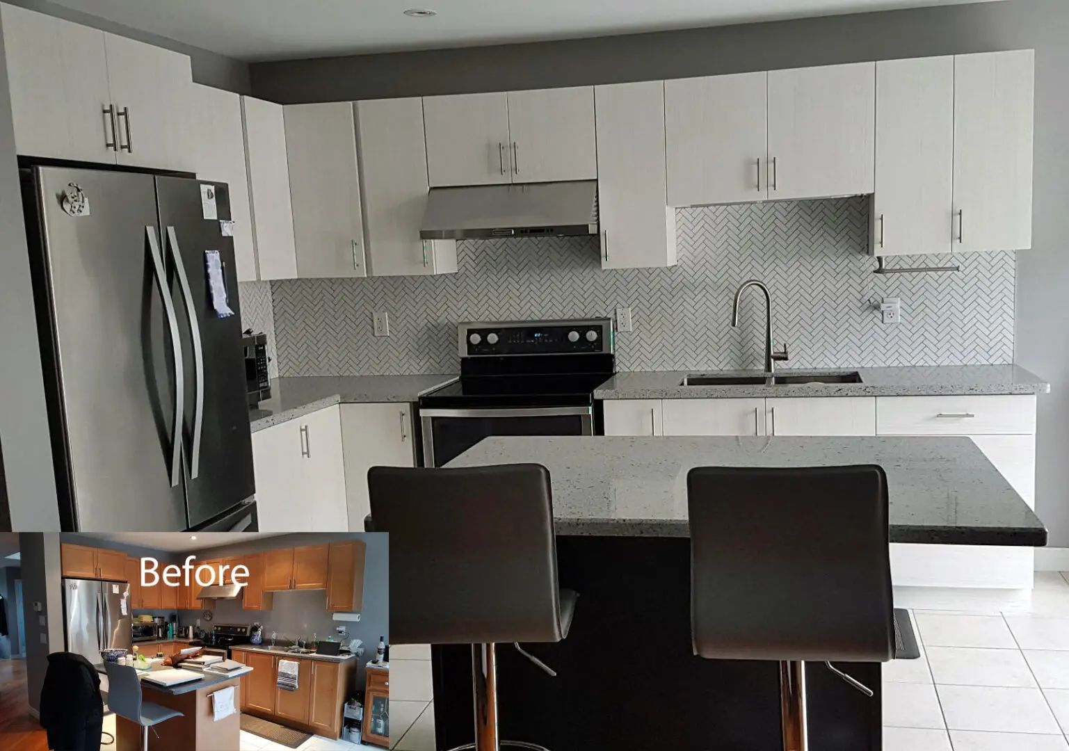 Modern white kitchen with stainless steel appliances, dark island, and grey countertops.