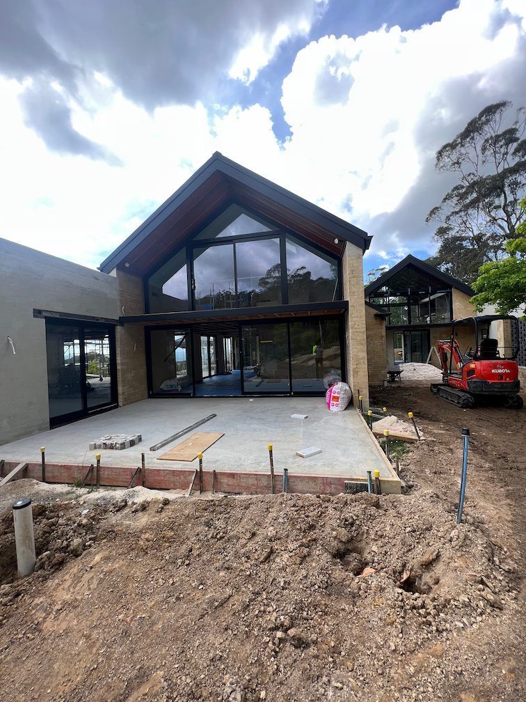 A Large House Is Under Construction In The Middle Of A Dirt Field — SG Glass & Aluminium in Wagga Wagga, NSW