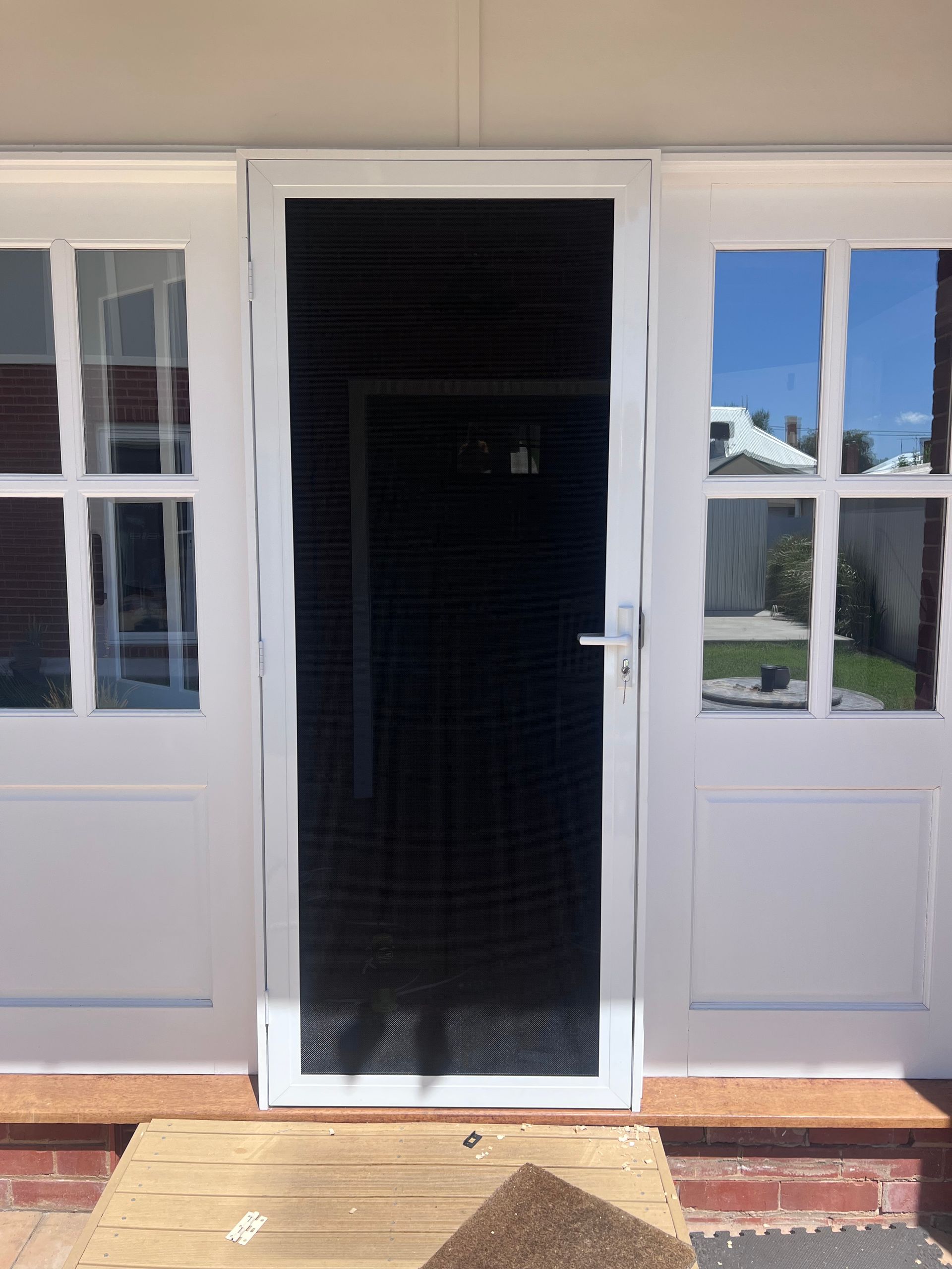 A White Front Door Closed With New Fly Screen — SG Glass & Aluminium in Wagga Wagga, NSW
