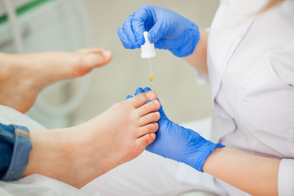 A Person Is Getting A Foot Treatment From A Doctor — Kingaroy Podiatry Foot Care Clinic in Kingaroy, QLD