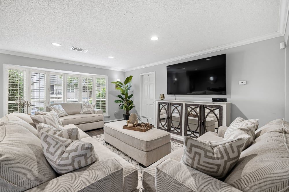 a living room filled with furniture and a flat screen tv at The Park at Flower Mound in Flower Mound, TX.