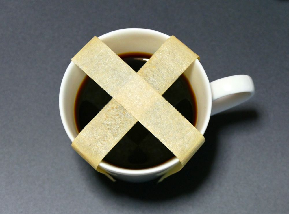 A cup of coffee is taped with duct tape