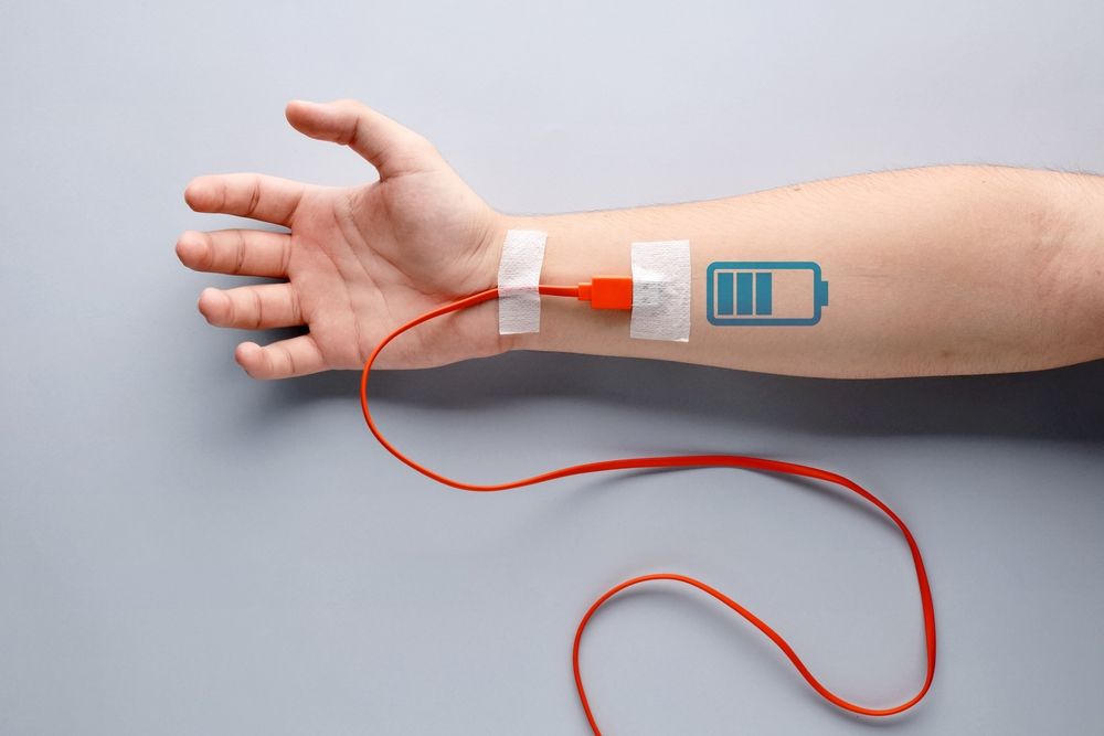 A person has a tattoo of a battery on their arm.