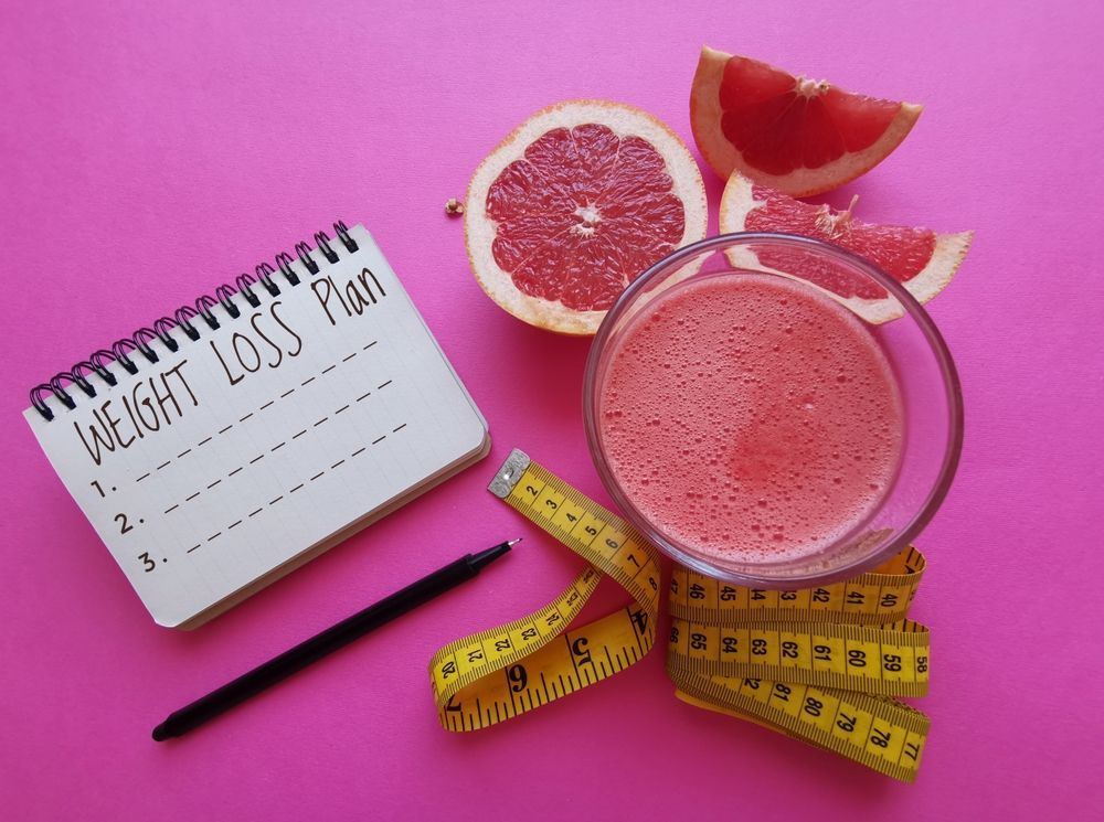 A notebook with a weight loss plan written on it