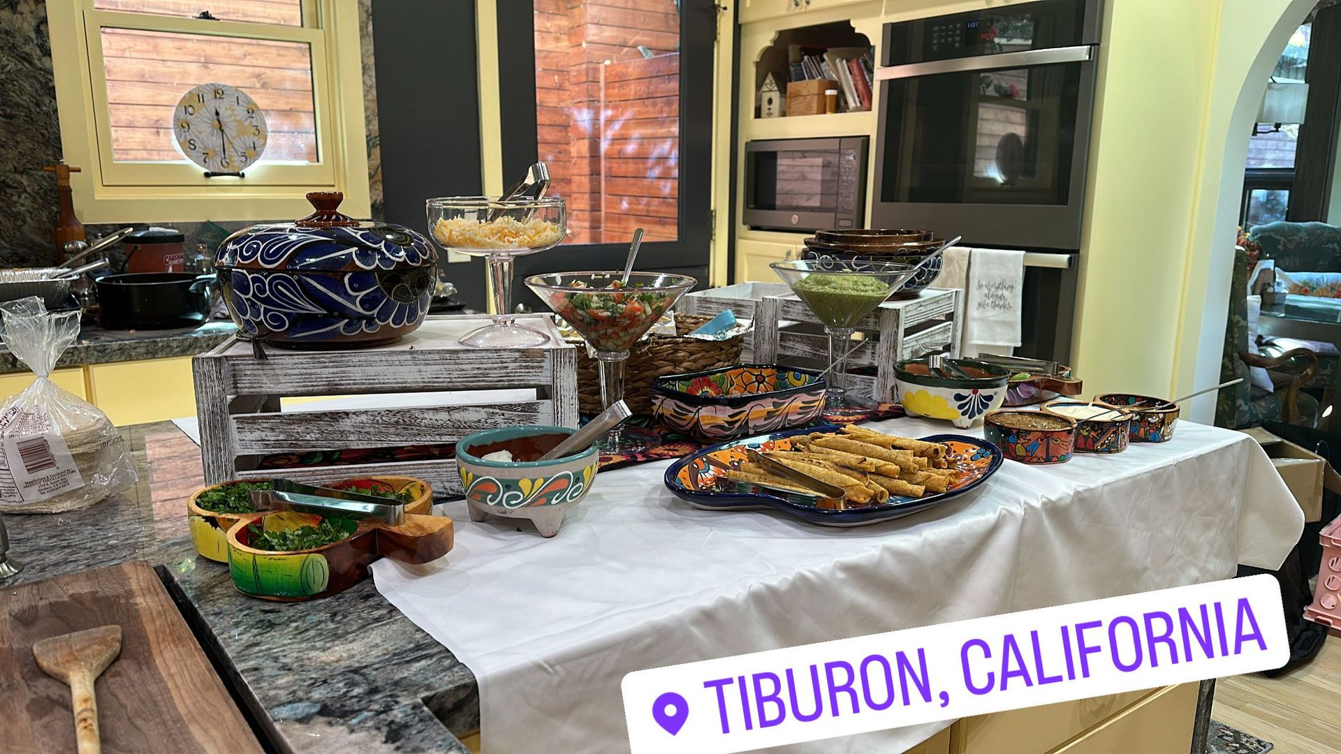 A buffet table in Tiburon, California, with colorful Mexican dishes.