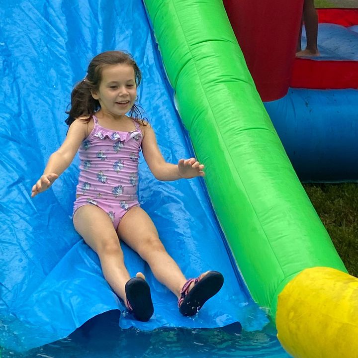A Kid Sliding on a Pool Slide A Kid Sliding on a Pool Slide