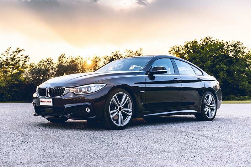 Car Parked Outside with Sunset and Trees | Rolf's Import Auto Service