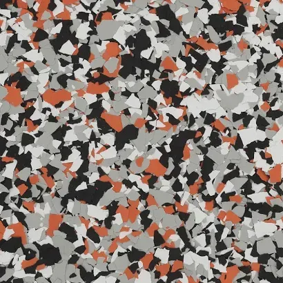 Abstract mosaic of scattered black, gray, white, and orange shards