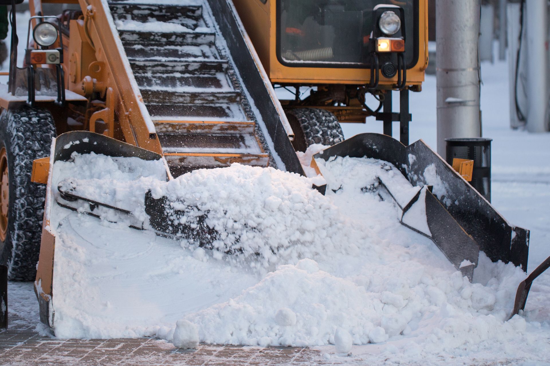 Snowplow pushing snow on a road in winter
