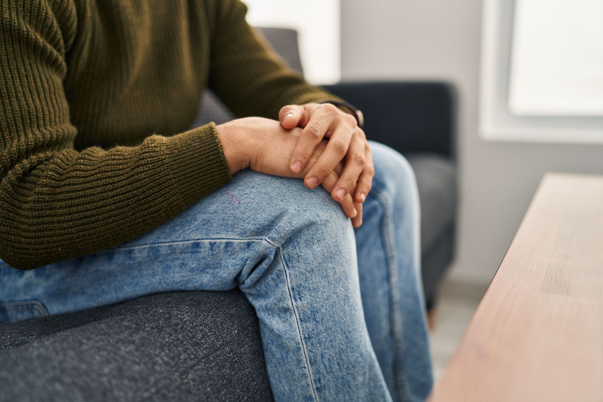 Individual seated in a counseling office during a one-on-one therapy and support session.