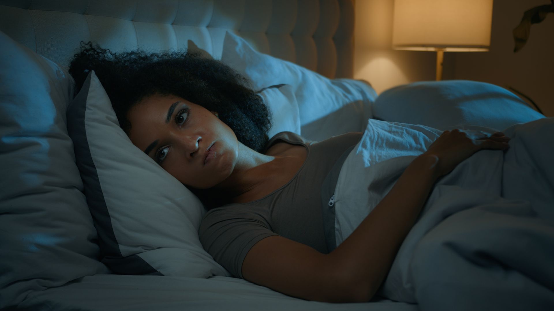 woman listening to bed squeak