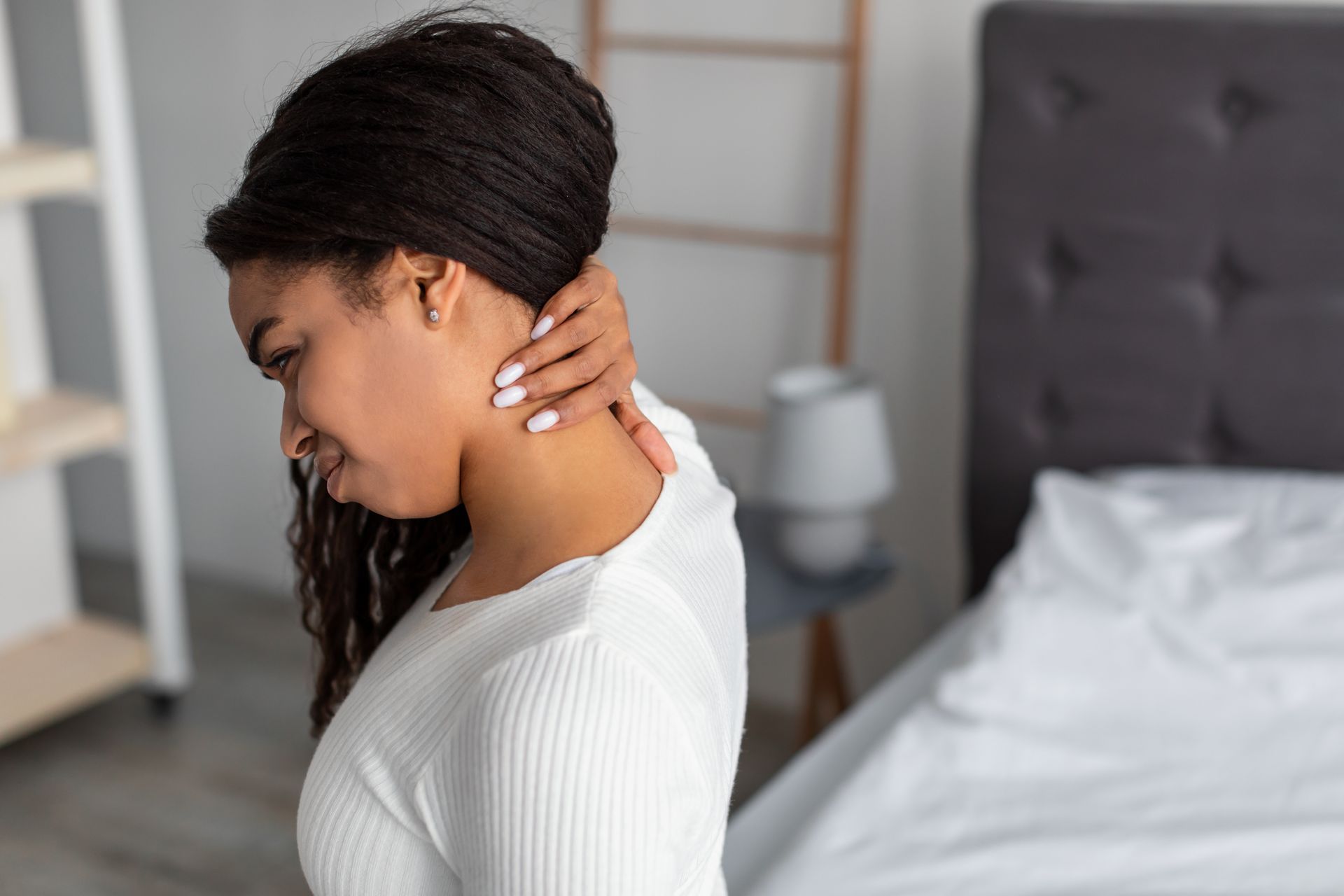woman waking up with neck pain
