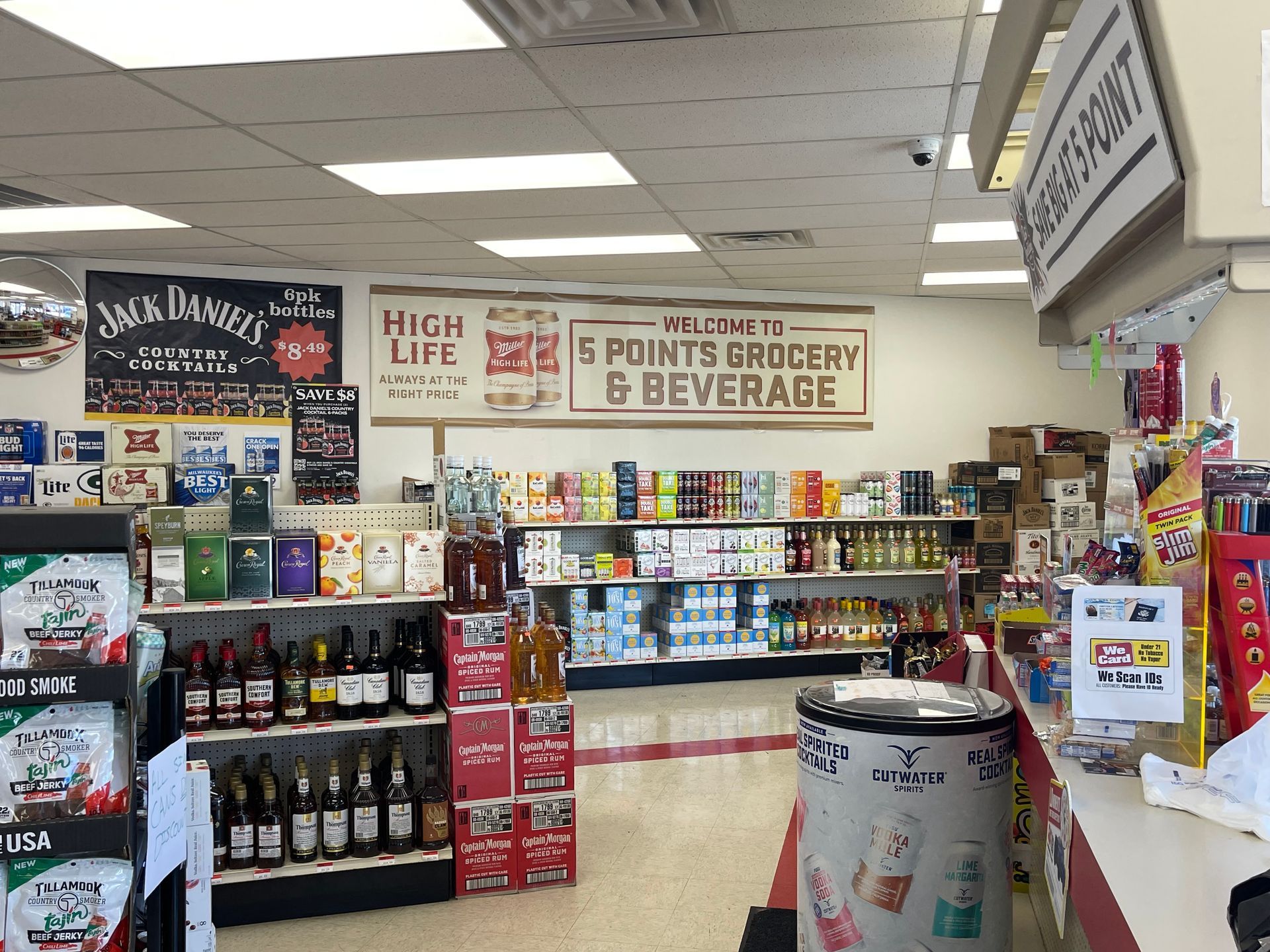 Interior of a convenience store, showcasing shelves of drinks and snacks. Signage indicates "5 Points Grocery & Beverage".