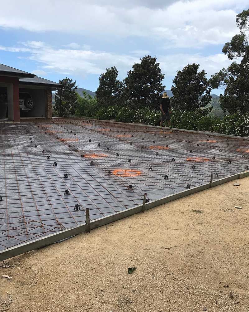 Concrete Driveway Is Being Built In Front Of A House — Providing Steel & Concrete Construction In Byron Bay, NSW