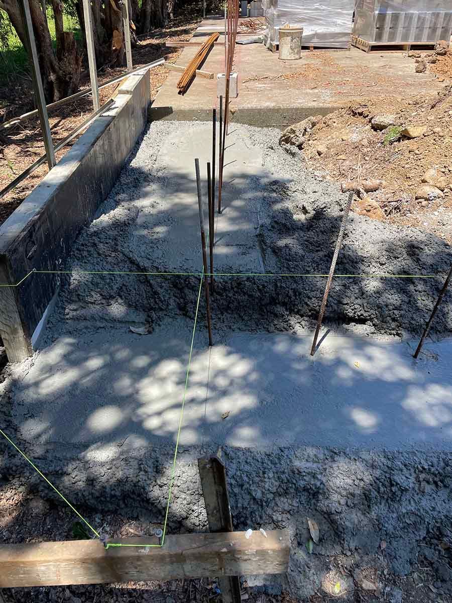Pile Of Concrete Is Being Poured On A Construction Site — Providing Steel & Concrete Construction In Byron Bay, NSW